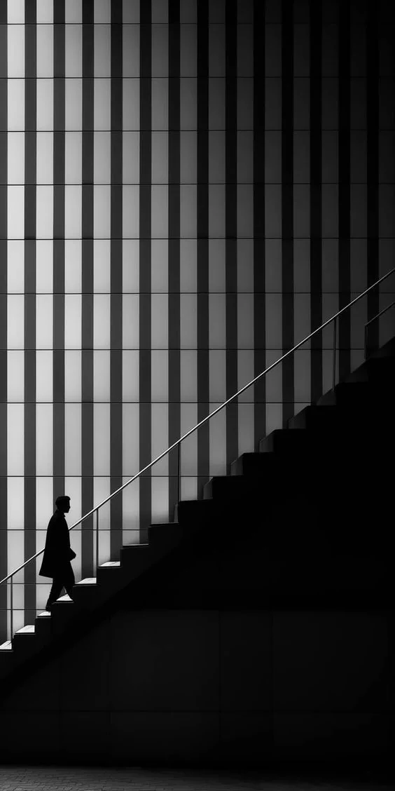 Figure ascending a staircase as a metaphor for business transition